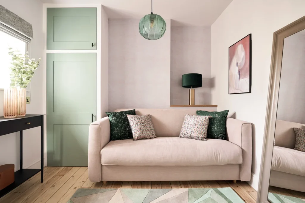 Rose coloured sofa against a complimentary pink wall with light green accent features — Kate Lovejoy Interiors speaks about toxic chemicals in furniture