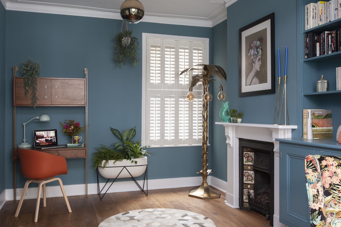 6-This-vibrant-and-functional-study-area-features-a-mid-century-modern-desk-paired-with-an-orange-accent-chair-complemented-by-greenery-and-a-striking-gold-palm-tree-floor-lamp.jpeg