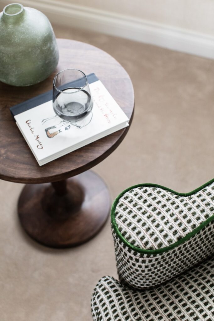 Fulham interior designer detail shot of a green/cream armchair and side table