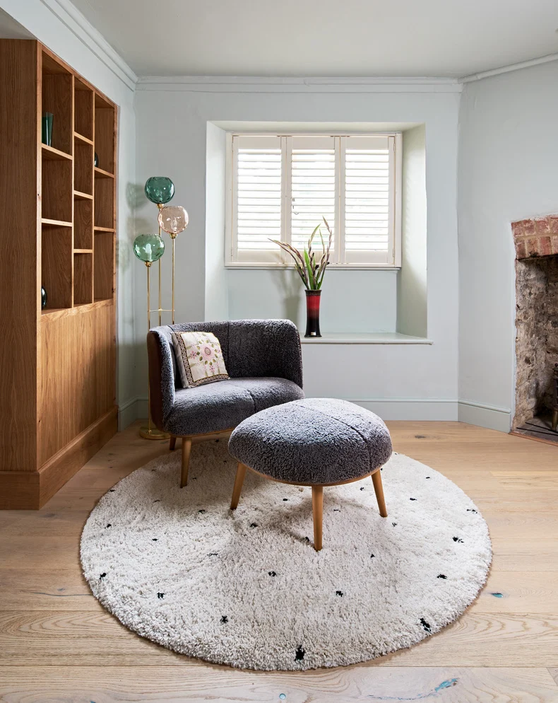 A Wandsworth interior designer created this calm snug reading space with large chair and footstool