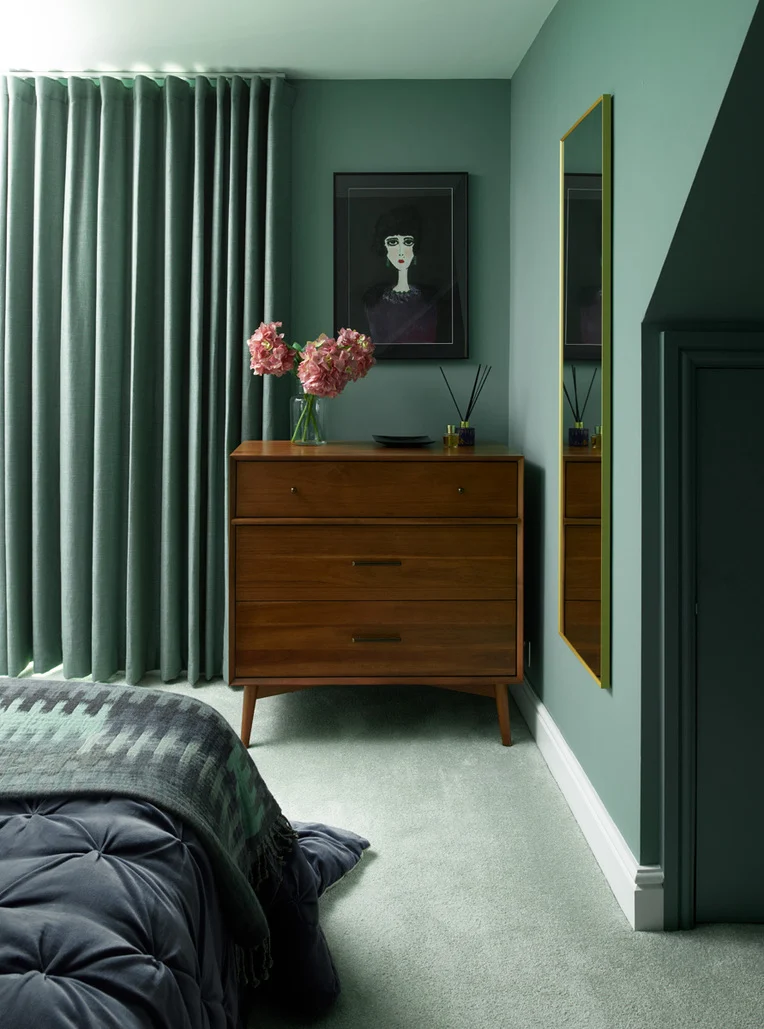 Interior Designer in Hammersmith created a calm sage green bedroom with a mid century inspired chest of drawers