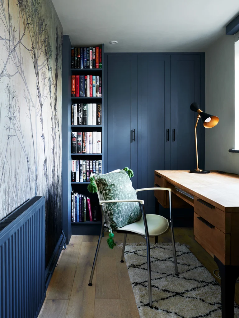 Interior designer in Maidenhead created this narrow navy study with feature wallpaper