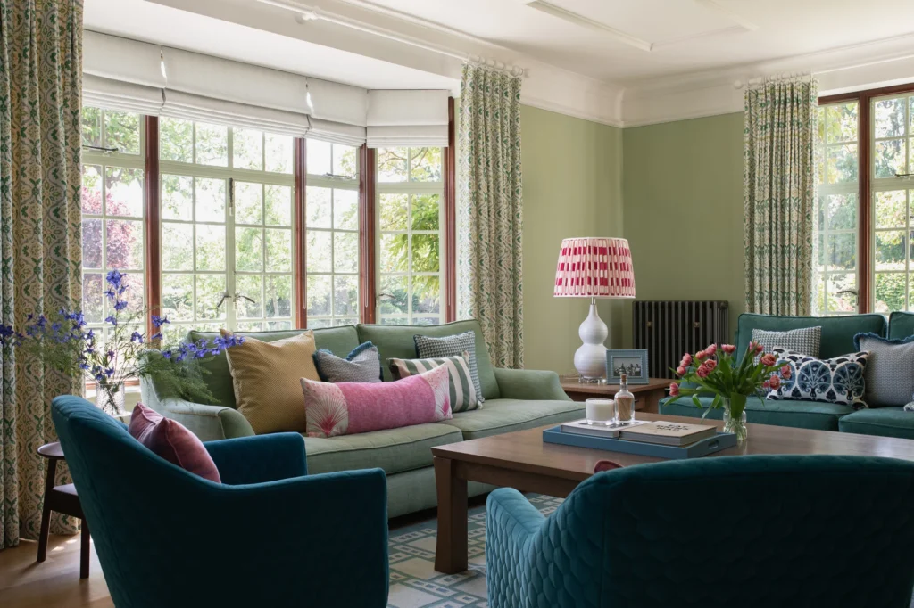 a beautiful lounge in a Home by Kate Lovejoy Interiors in sage greens, pinks and teal