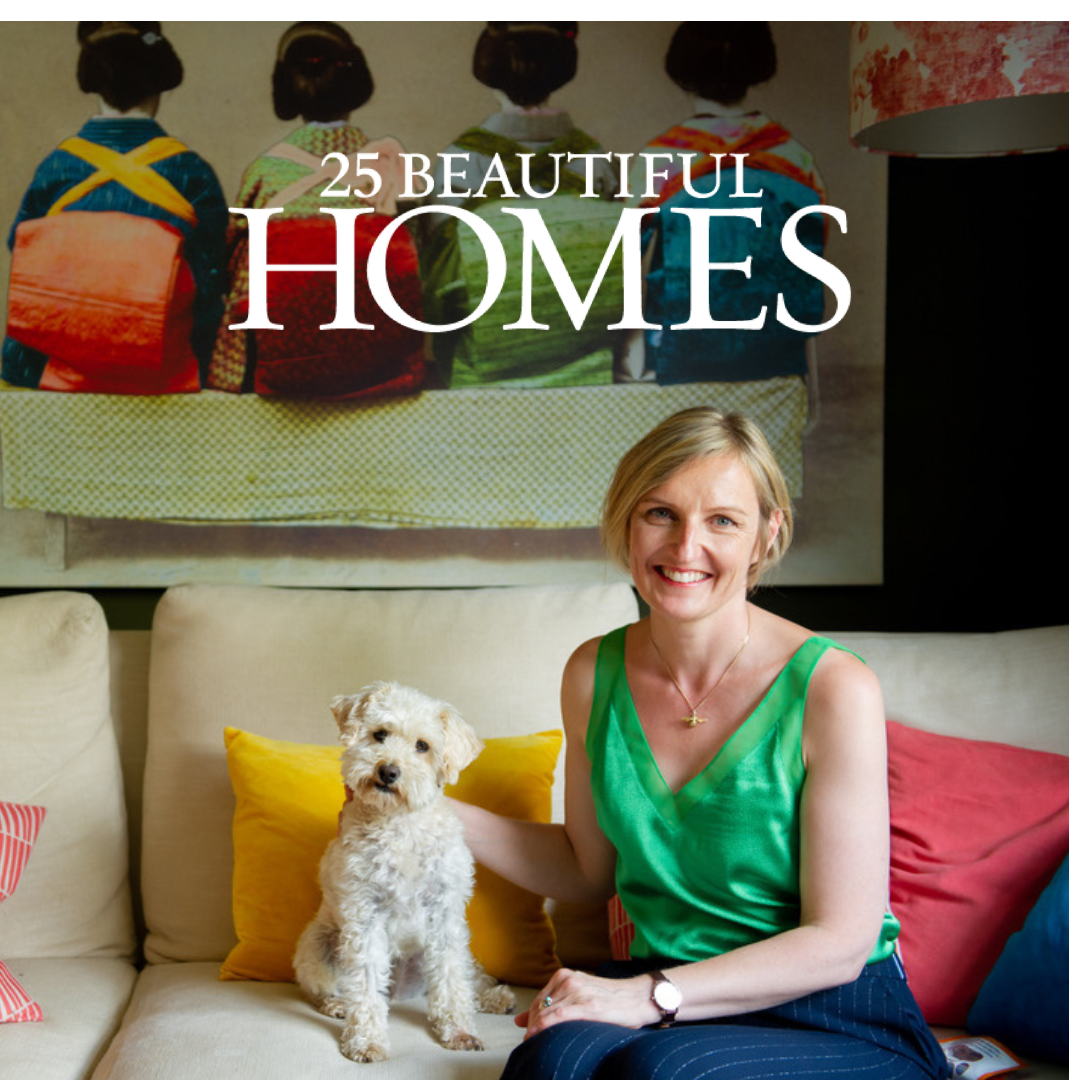 Kate Lovejoy and her White Dog on a sofa with colourful art behind