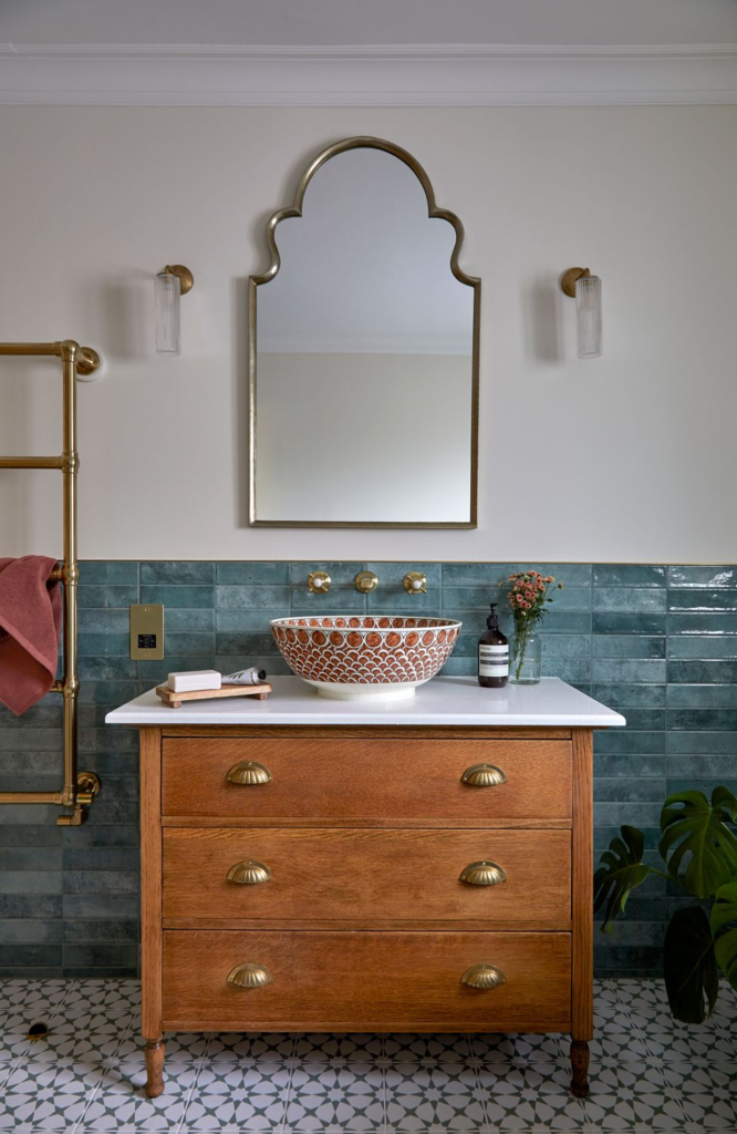 Finished bathroom with teal tiles, a walnut vanity unit and accent mirror from Kate Lovejoy Interiors Colour and Style Consultation.