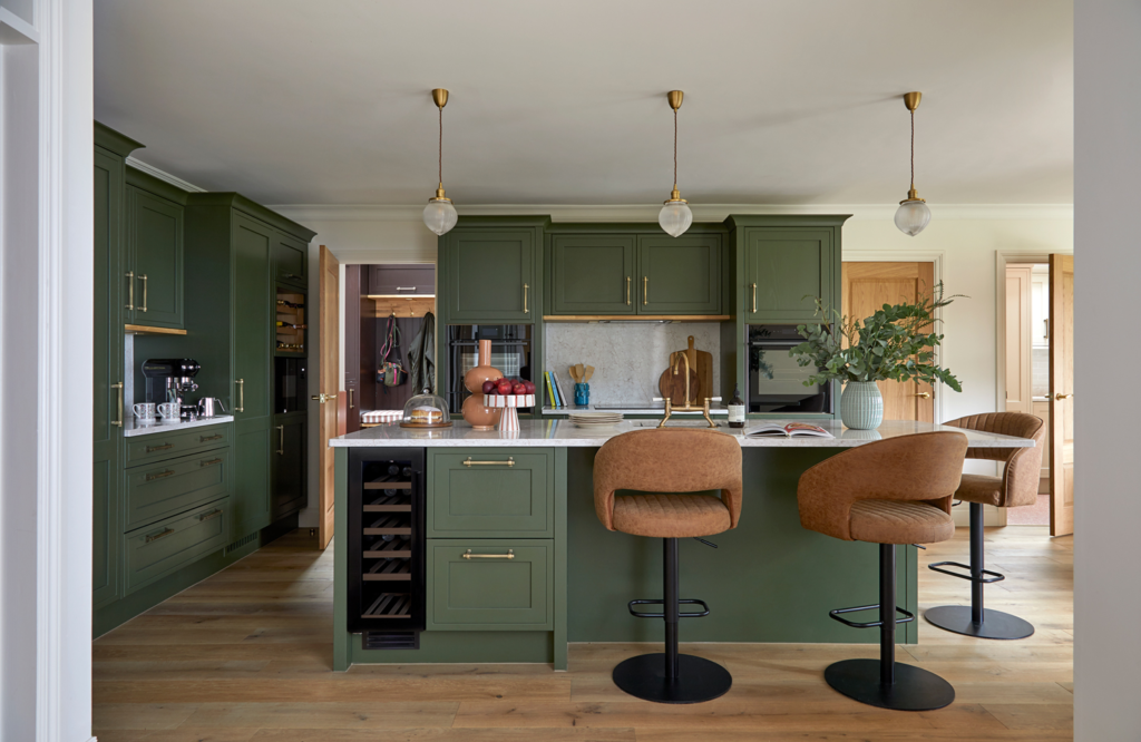 How to plan your renovation: olive green kitchen with brown leather chairs and accents, styled for a warm and modern family home by Kate Lovejoy Interiors.
